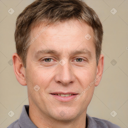 Joyful white adult male with short  brown hair and grey eyes