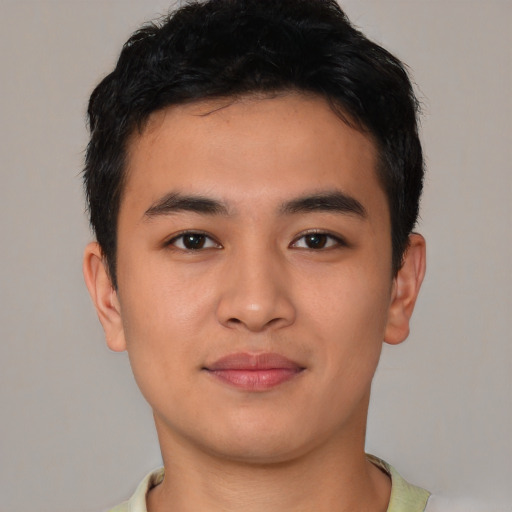 Joyful asian young-adult male with short  brown hair and brown eyes