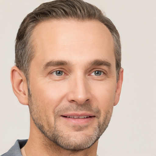 Joyful white adult male with short  brown hair and brown eyes