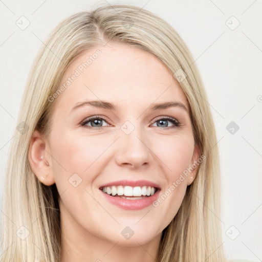 Joyful white young-adult female with long  brown hair and blue eyes