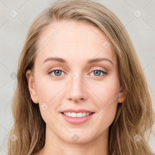 Joyful white young-adult female with long  brown hair and blue eyes