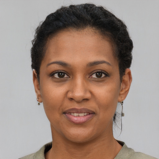 Joyful black young-adult female with short  brown hair and brown eyes