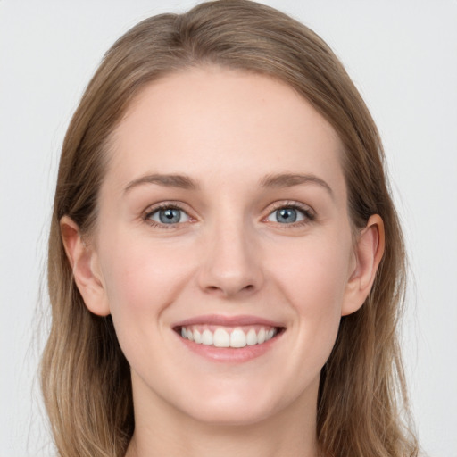 Joyful white young-adult female with long  brown hair and blue eyes