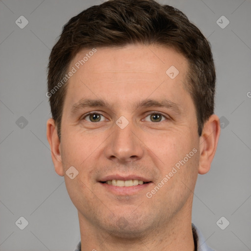 Joyful white young-adult male with short  brown hair and grey eyes