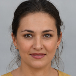 Joyful white young-adult female with medium  brown hair and brown eyes