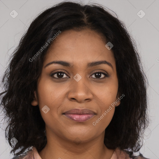 Joyful black young-adult female with long  brown hair and brown eyes