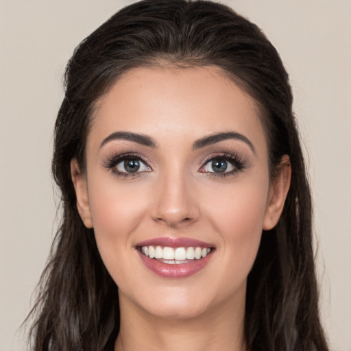 Joyful white young-adult female with long  brown hair and brown eyes