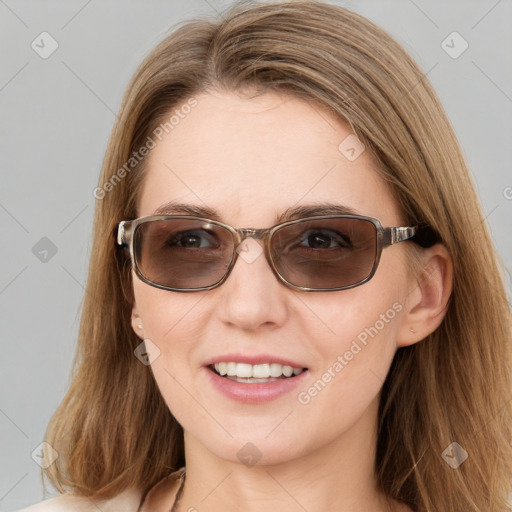 Joyful white young-adult female with long  brown hair and blue eyes