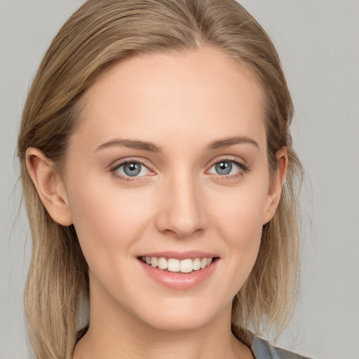 Joyful white young-adult female with long  brown hair and grey eyes