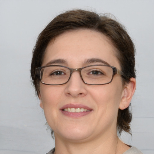 Joyful white adult female with medium  brown hair and brown eyes