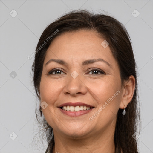 Joyful white adult female with medium  brown hair and brown eyes