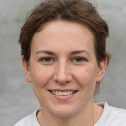 Joyful white adult female with short  brown hair and brown eyes