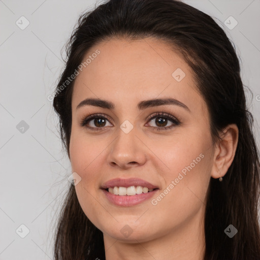 Joyful white young-adult female with long  brown hair and brown eyes