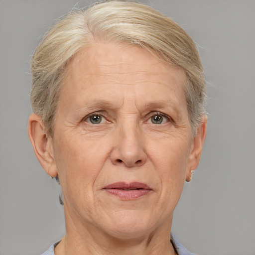 Joyful white middle-aged female with short  gray hair and brown eyes