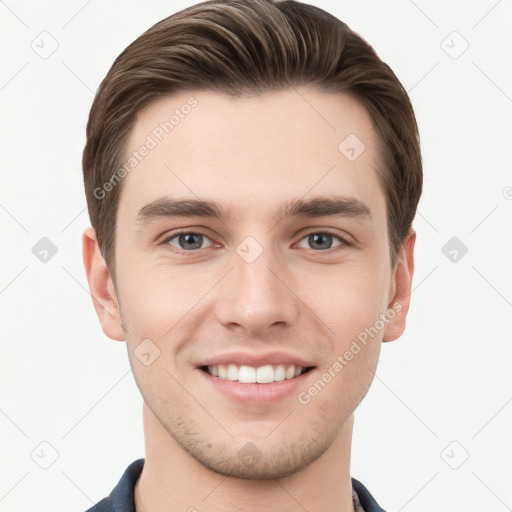 Joyful white young-adult male with short  brown hair and grey eyes