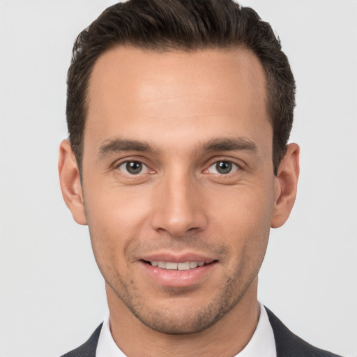 Joyful white young-adult male with short  brown hair and brown eyes