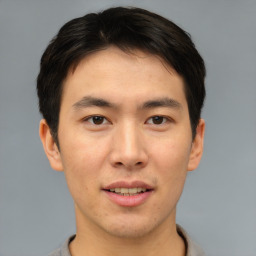 Joyful asian young-adult male with short  brown hair and brown eyes