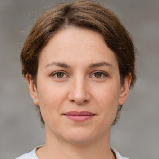 Joyful white young-adult female with medium  brown hair and green eyes