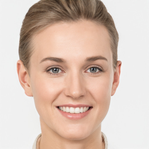 Joyful white young-adult female with short  brown hair and grey eyes