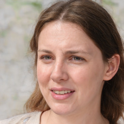 Joyful white adult female with medium  brown hair and grey eyes