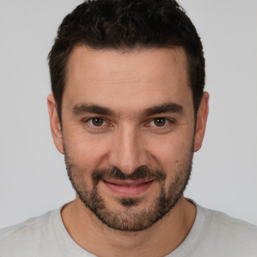 Joyful white young-adult male with short  black hair and brown eyes