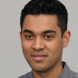 Joyful latino young-adult male with short  black hair and brown eyes