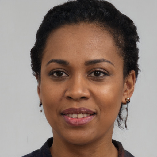 Joyful black young-adult female with medium  black hair and brown eyes