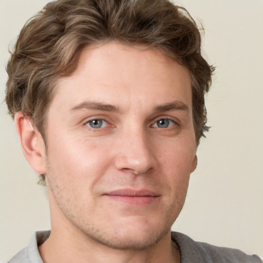 Joyful white adult male with short  brown hair and grey eyes