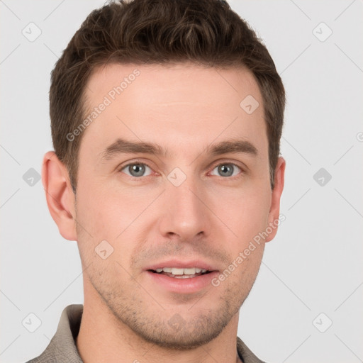 Joyful white young-adult male with short  brown hair and grey eyes