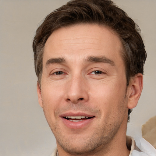 Joyful white adult male with short  brown hair and brown eyes