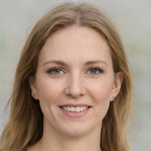 Joyful white young-adult female with medium  brown hair and blue eyes