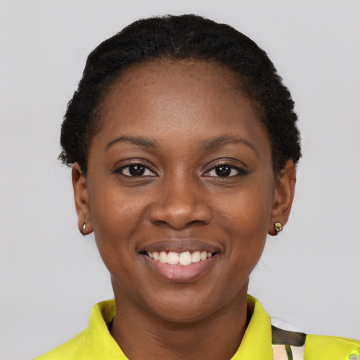 Joyful black young-adult female with short  black hair and brown eyes