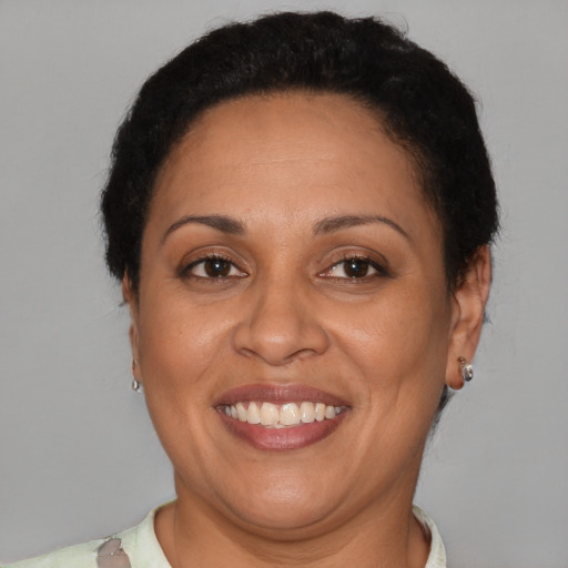 Joyful latino adult female with short  brown hair and brown eyes