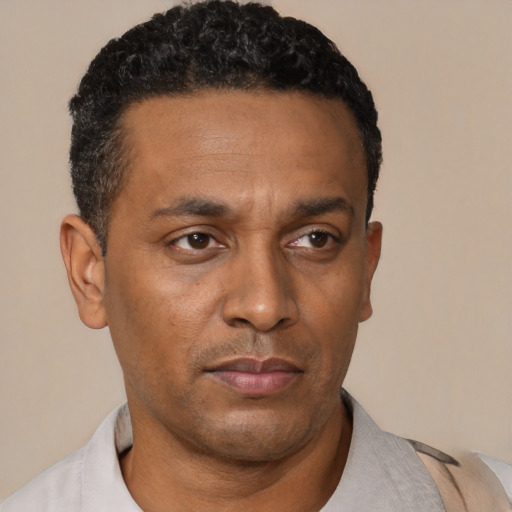 Neutral black adult male with short  black hair and brown eyes