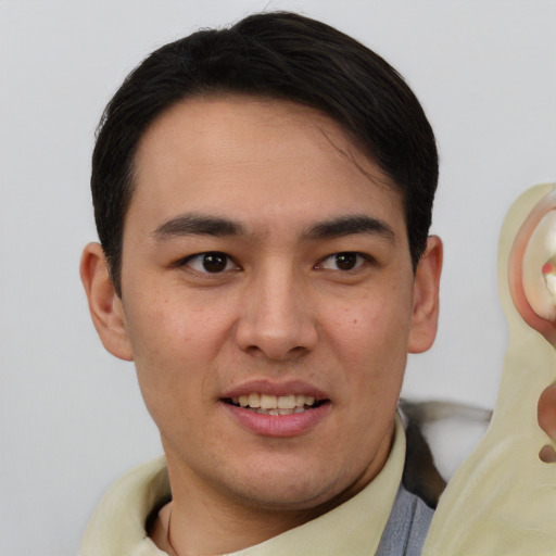 Joyful white young-adult male with short  black hair and brown eyes