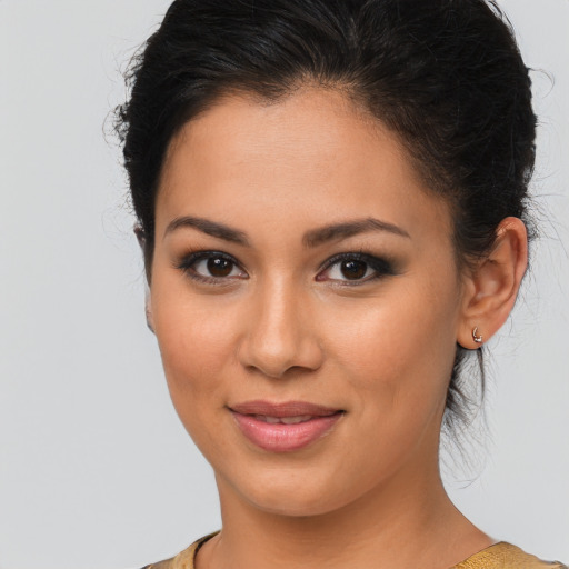 Joyful latino young-adult female with medium  brown hair and brown eyes