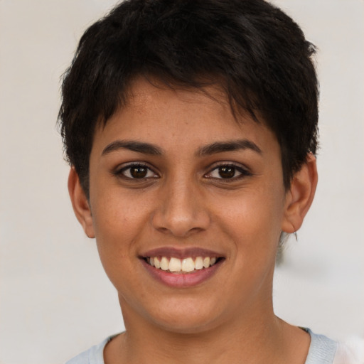 Joyful latino young-adult female with short  brown hair and brown eyes