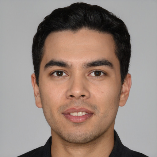 Joyful white young-adult male with short  black hair and brown eyes