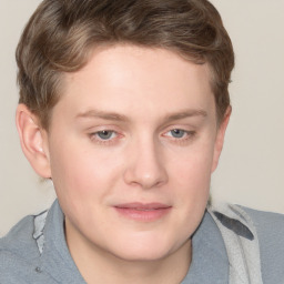 Joyful white young-adult male with short  brown hair and blue eyes