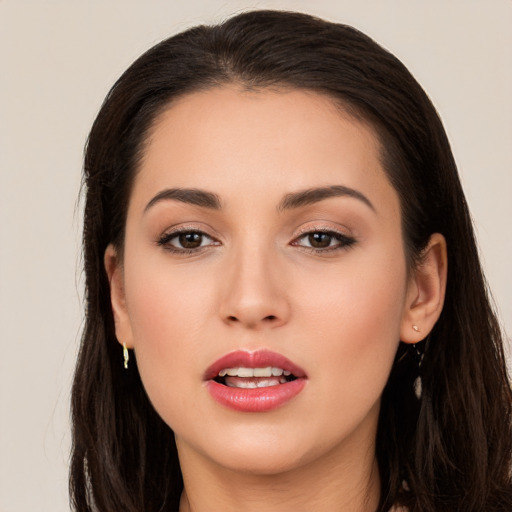 Joyful white young-adult female with long  brown hair and brown eyes