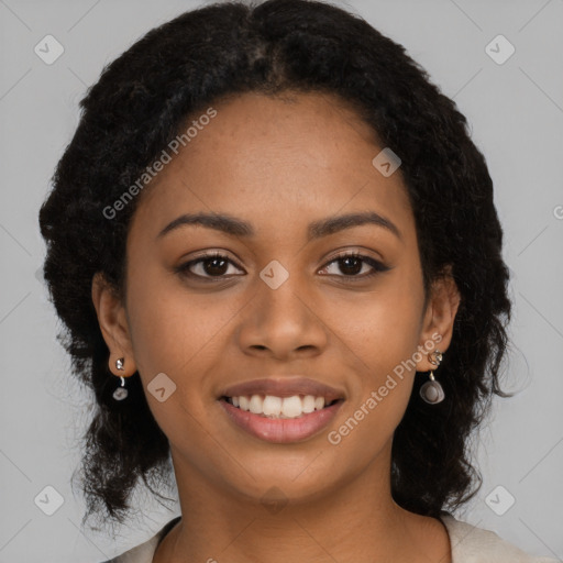 Joyful black young-adult female with long  black hair and brown eyes