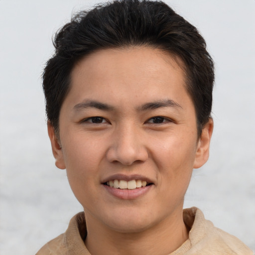 Joyful asian young-adult male with short  brown hair and brown eyes
