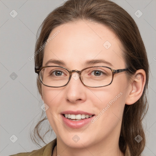 Joyful white young-adult female with medium  brown hair and grey eyes