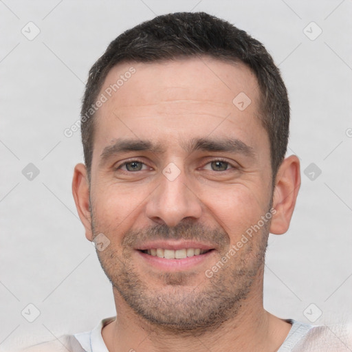 Joyful white young-adult male with short  black hair and brown eyes