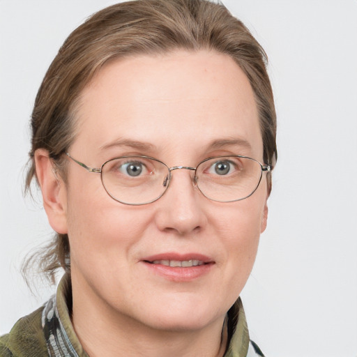 Joyful white adult female with medium  brown hair and blue eyes