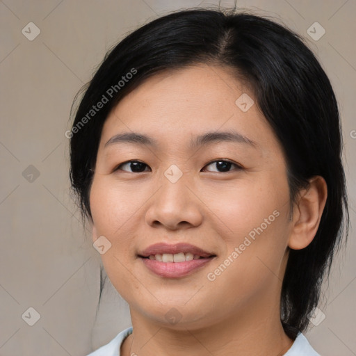 Joyful asian young-adult female with medium  black hair and brown eyes