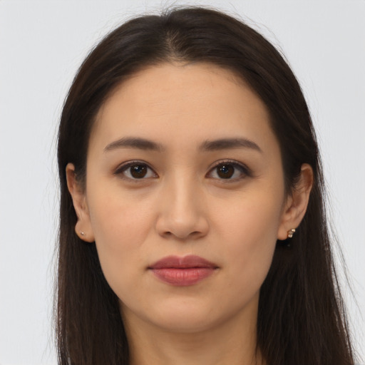 Joyful latino young-adult female with long  brown hair and brown eyes
