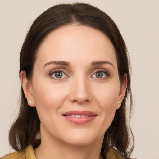 Joyful white young-adult female with long  brown hair and grey eyes