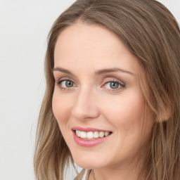 Joyful white young-adult female with long  brown hair and blue eyes