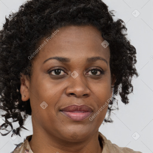 Joyful black adult female with short  brown hair and brown eyes